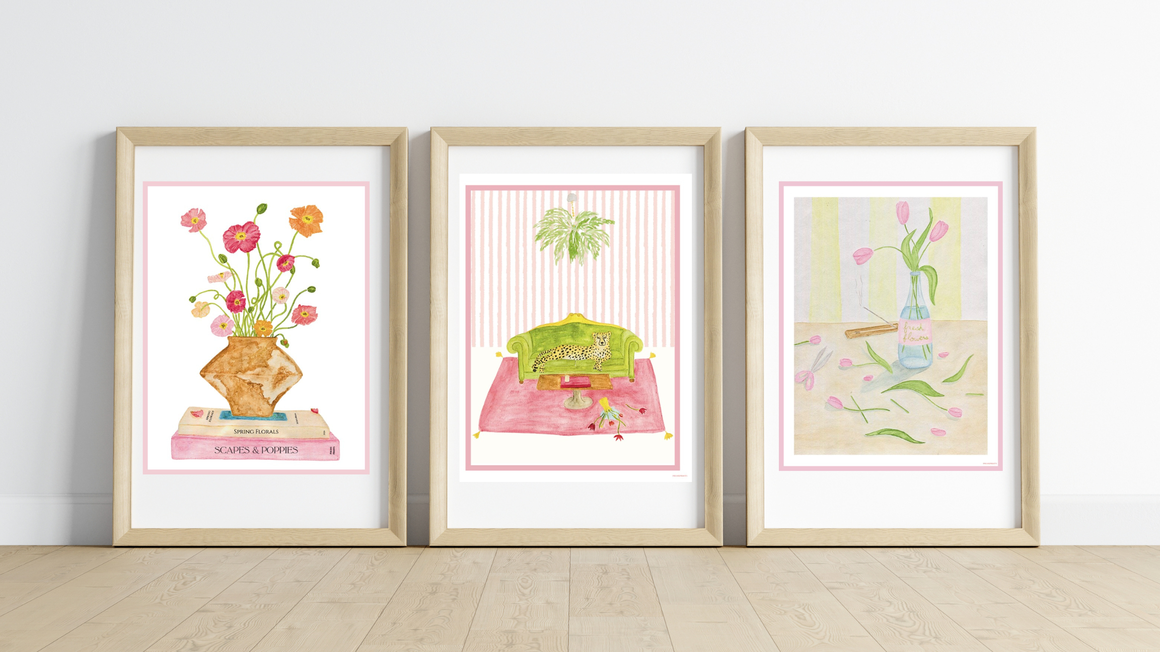 Three Pruneprints framed artworks on a wall with a light wooden floor.